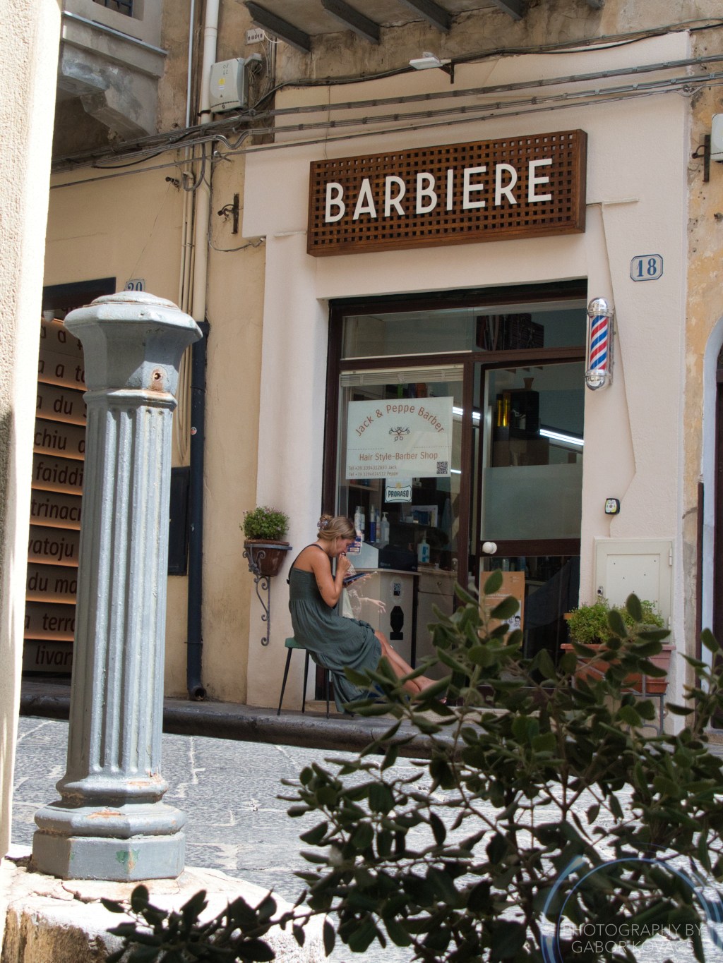 waiting outside the barber’s&nbsp;shop